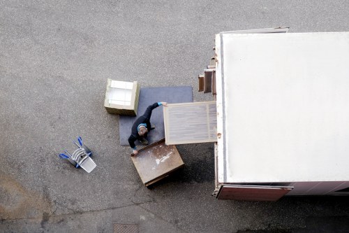Packed office boxes and furniture ready for relocation in an East London workspace