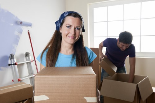Moving crew carrying furniture into a Hackney flat