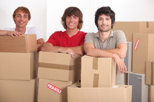 Moving crew handling desks and IT equipment during a Hackney office move