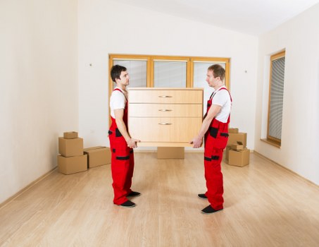 Local removals team handling furniture in a Hackney street with parking challenges