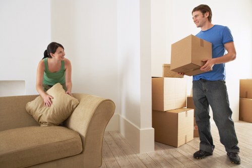 Furniture being carried from a flat with stair access in Hackney